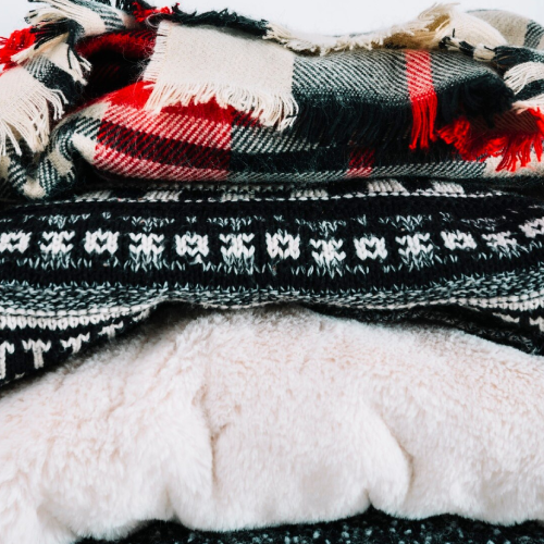 Pile of warm knitted clothes